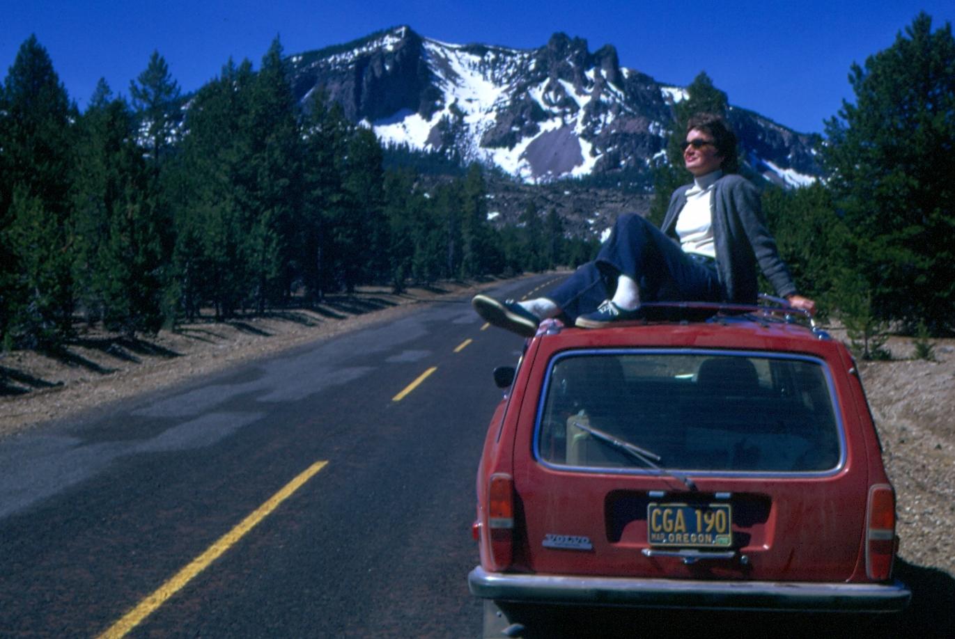 Nancy on top of station wagon